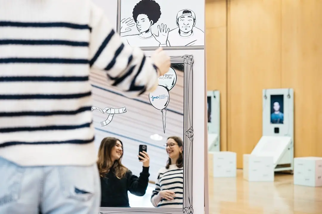 Spiegel mit Gegenständen und zwei Besucherinnen